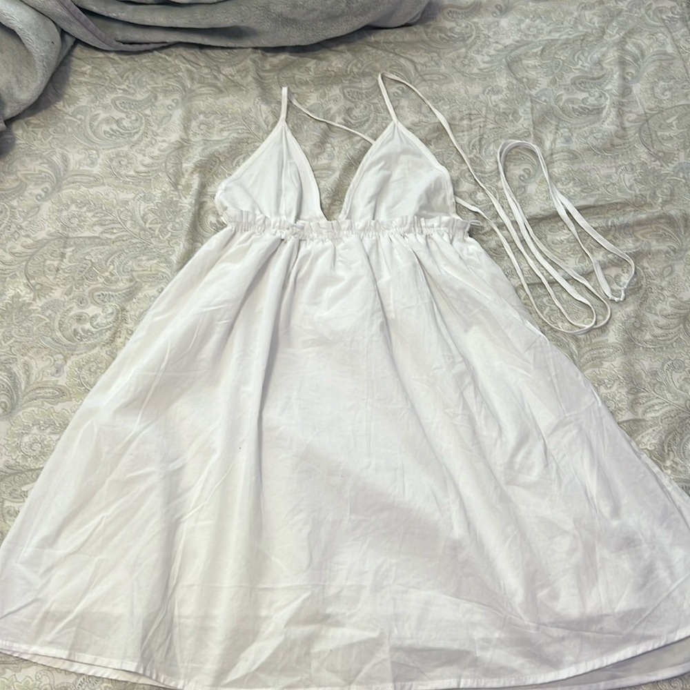 White sundress in a size S. Can be worn as a halter or strappy back.